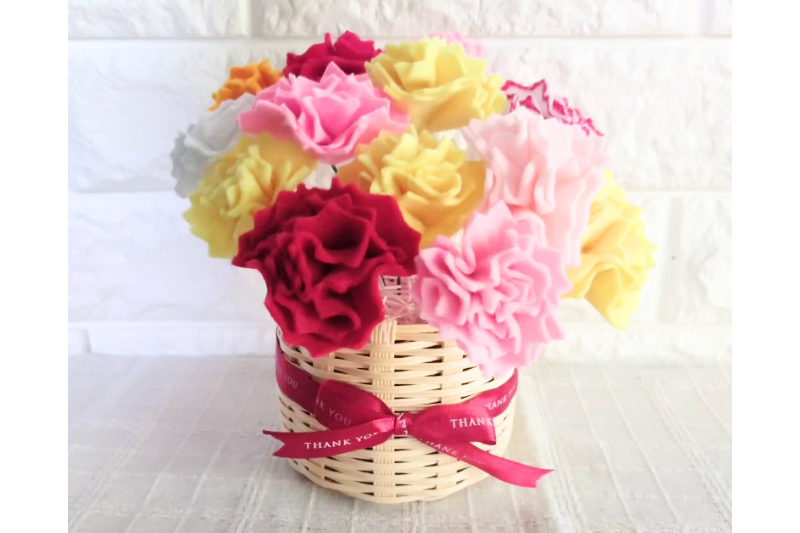 ハンドメイドのフェルトカーネーションが丸いカゴに入っている画像